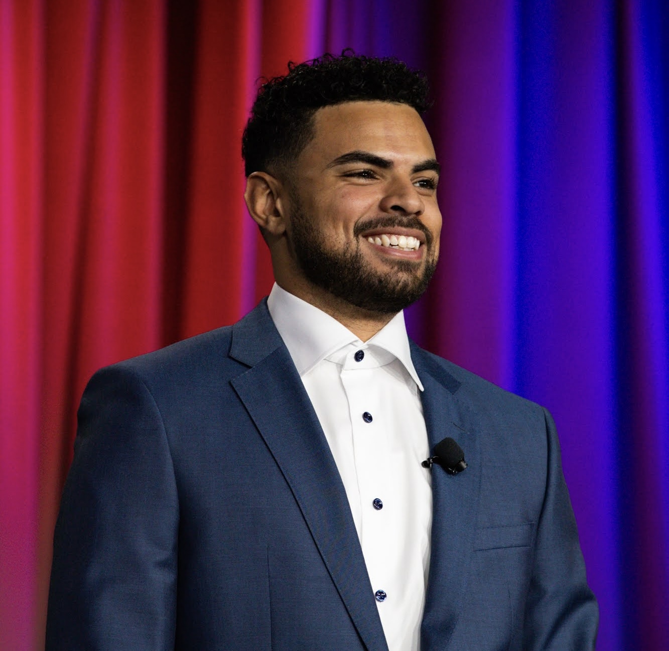 Portrait of Kenton D. Raiford smiling on stage